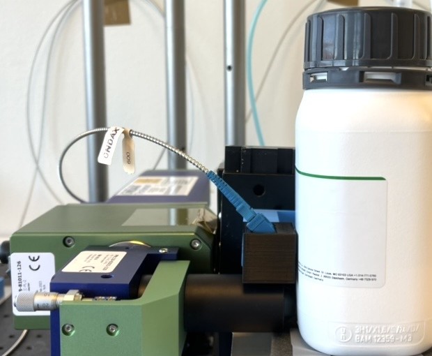 Close-up of a spectroscopy probe next to a pharmaceutical container